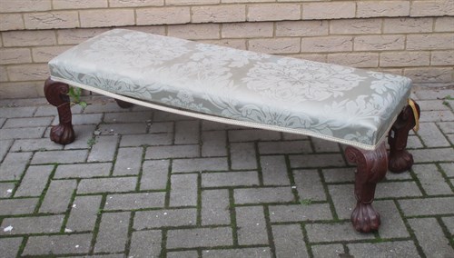 Lot 525 - An upholstered long stool on carved legs and...