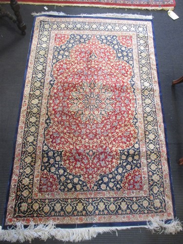 Lot 688 - A modern silk rug of pink madder grounds 58 x...