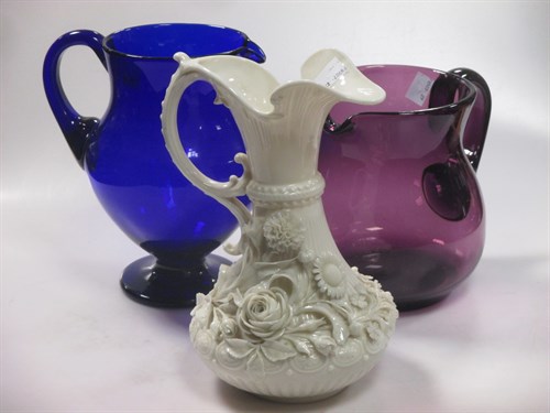 Lot 248 - An amethyst glass jug, a Beleek style ewer,...