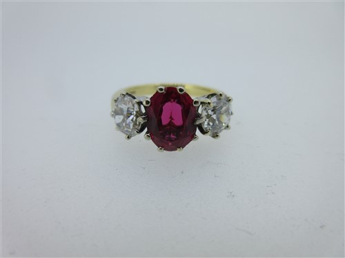 Lot 301 - A ruby and diamond three stone ring set in 18ct gold