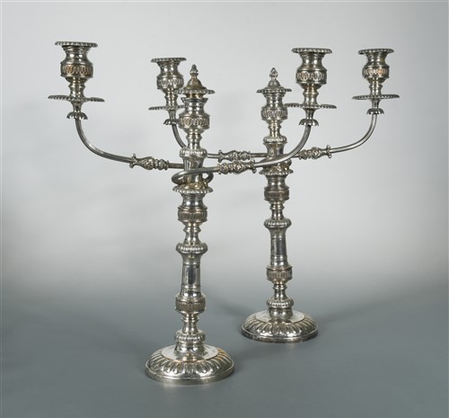 Lot 495 - A pair of silver plated three light candelabra