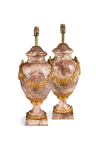 Lot 319 - A pair of early 20th century pink veined marble and gilt mounted urn lamps