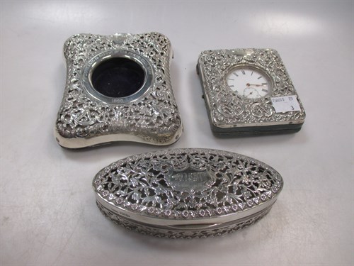 Lot 386 - Two silver embossed watch holders, one with a...