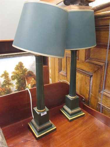 Lot 297 - A pair of green and gilt wooden column lamps...
