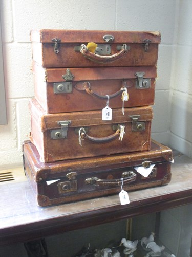 Lot 300 - Four leather cases, three embossed with the...
