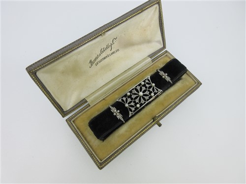 Lot 166 - A velvet ribbon choker, with early 20th century diamond and pearl set slides