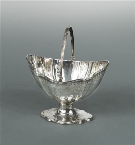 Lot 586 - A George III silver swing handled sugar basket