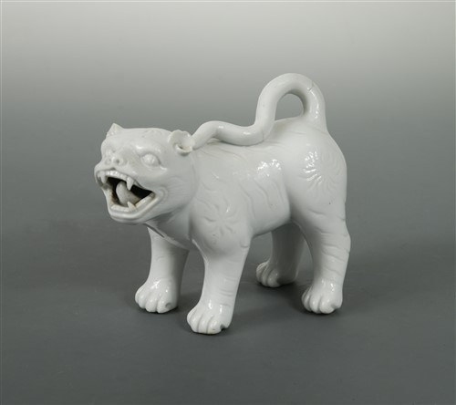 Lot 33 - A Japanese white glazed porcelain standing model of a Shi-Shi, probably Hirado Kilns, Meiji Period (1868-1912)