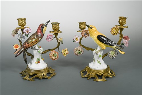 Lot 12 - A pair of German porcelain and ormolu mounted two-branch candlesticks