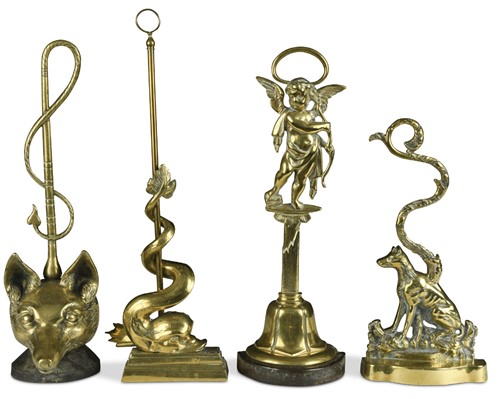 Lot 360 - Four brass door stops