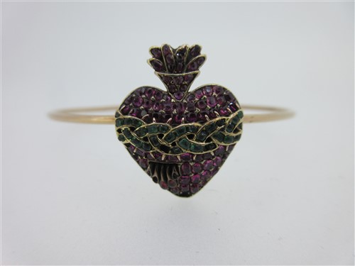 Lot 174 - An antique ruby sacred heart set on a later bangle