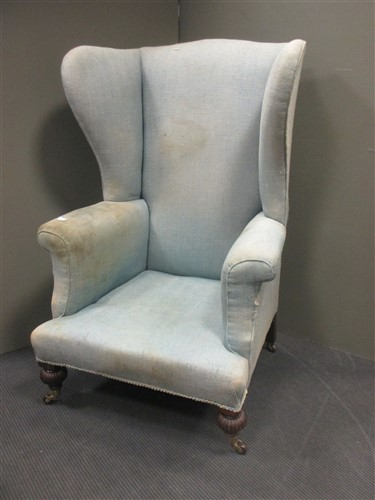 Lot 411 - A 19th century wing back armchair with high...