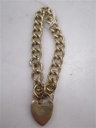Lot 210 - A 9ct gold crub link charm bracelet, 35.9g