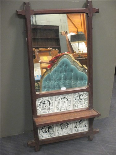 Lot 436 - A Gothic style oak wall mirror, decorated with...