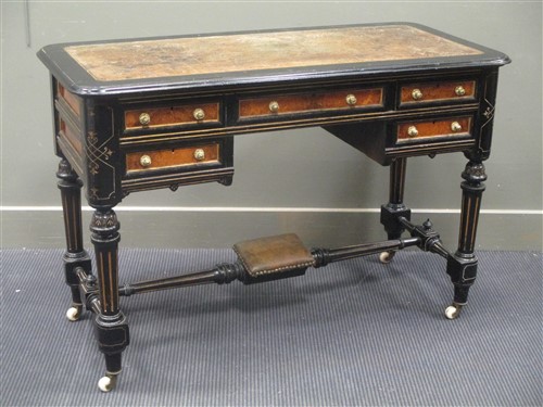 Lot 394 - An Aesthetic period ebonised desk with leather...