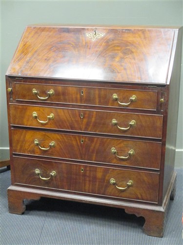 Lot 437 - A Georgian mahogany bureau on bracket feet