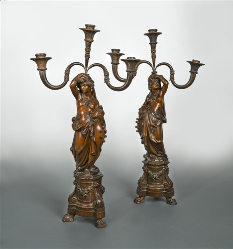 Lot 367 - A pair of Italian carved walnut figural candelabra