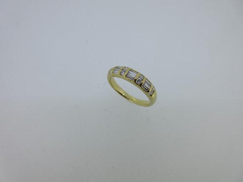 Lot 60 - An unusual diamond half hoop ring
