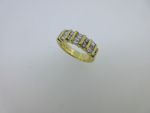 Lot 116 - A contemporary vari-cut diamond and 18ct gold half hoop ring