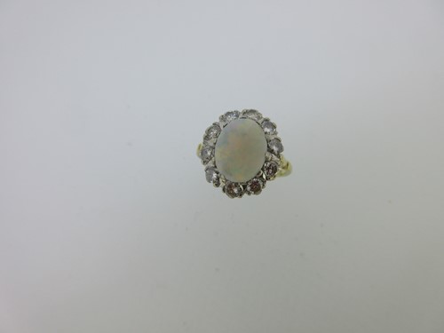 Lot 42 - An opal and diamond cluster ring set in hallmarked gold