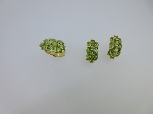 Lot 26 - A peridot and diamond ring and earring suite