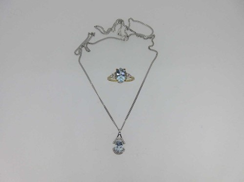 Lot 121 - An aquamarine and diamond pendant together with a similarly set ring