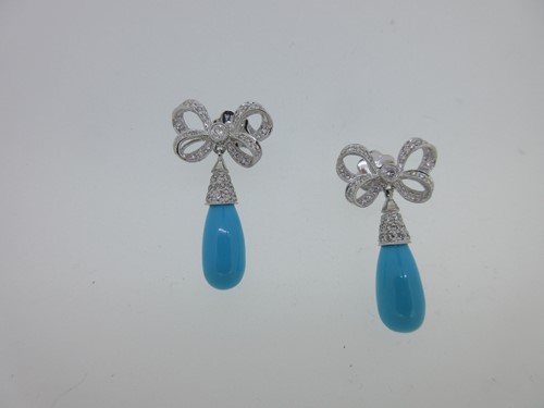 Lot 157 - A pair of diamond and turquoise bow and drop earpendants