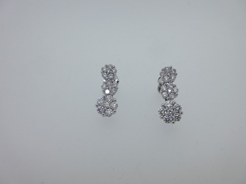 Lot 47 - A pair of triple cluster diamond pendant earrings