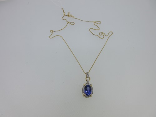 Lot 176 - A tanzanite, diamond and 18ct gold pendant and chain