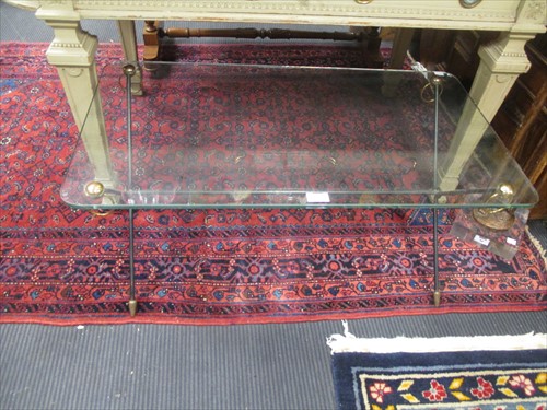 Lot 582 - A modern glass top coffee table on iron...