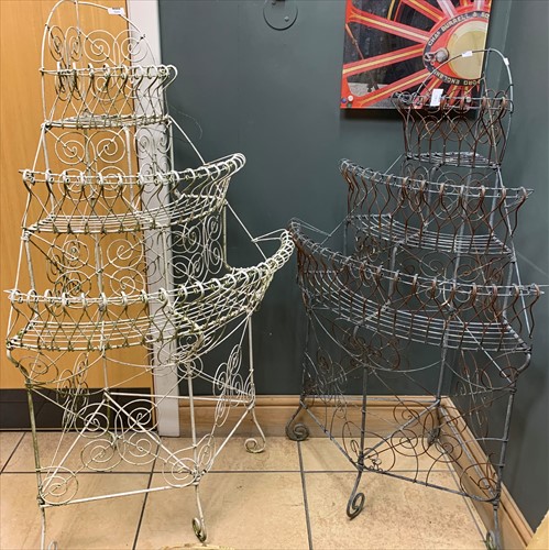 Lot 595 - A near pair of wirework tiered plant stands,...