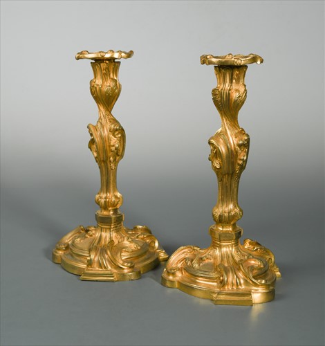 Lot 244 - A pair of late 19th century Rococo style gilt bronze candlesticks