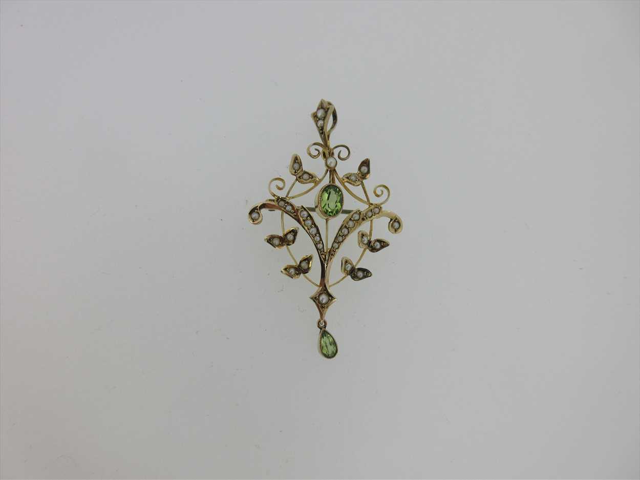 Lot 214 - An Edwardian peridot and seed pearl pendant / brooch