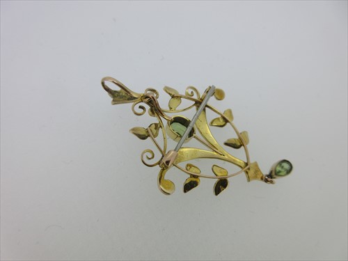 Lot 214 - An Edwardian peridot and seed pearl pendant / brooch