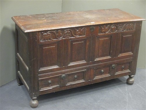 Lot 431 - An 18th century oak mule chest with carved...