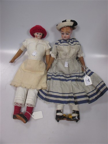 Lot 22 - A wax head doll, a bisque shoulder headed doll...