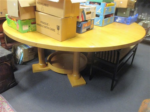Lot 397 - A large blonde oak circular pedestal dining...