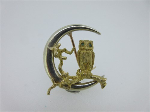 Lot 148 - A bi-coloured gold owl and crescent moon brooch by Alabaster & Wilson