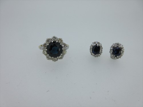 Lot 88 - A sapphire and diamond cluster ring together with a pair of similarly set earstuds