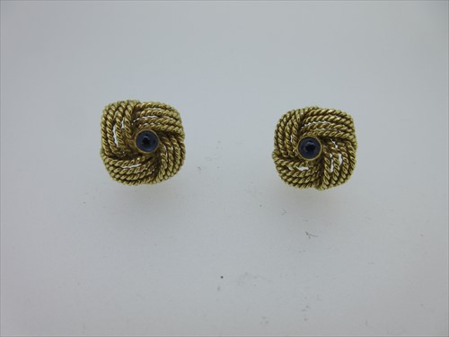 Lot 62 - A pair of 18ct gold knot earstuds with sapphire centres