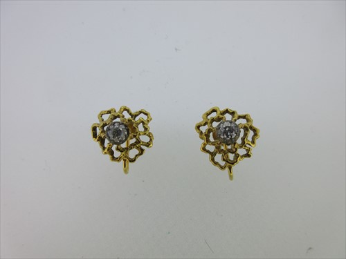 Lot 111 - A pair of gold and diamond screw back earrings