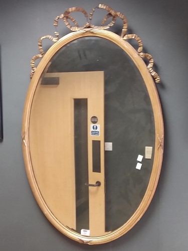 Lot 535 - An oval gilt gesso wall mirror, with ribbon...