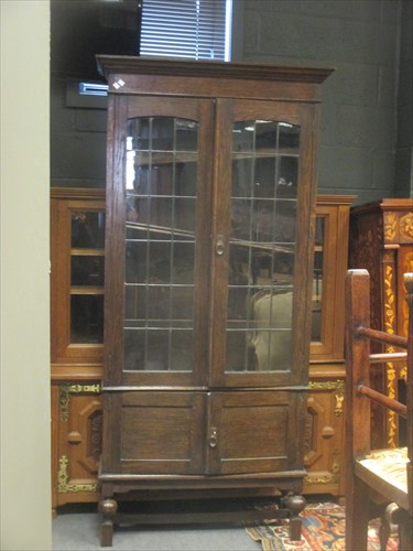 Lot 631 - An oak bookcase with leaded glazed doors, 204...