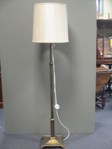 Lot 120 - A brass lamp standard and a spinning wheel