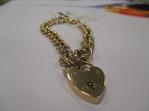 Lot 235 - A charm bracelet stamped '15c'