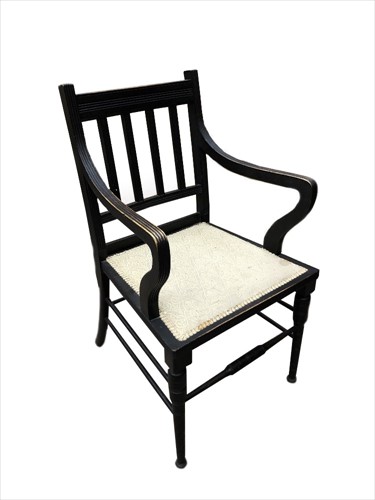 Lot 151 - In the manner of E. W. Godwin, an Aesthetic period ebonised elbow chair