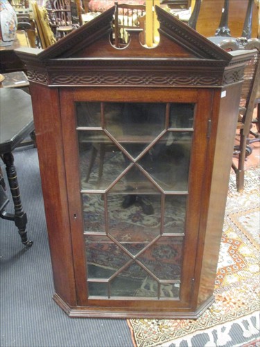 Lot 624 - A George III mahogany hanging corner cupboard,...