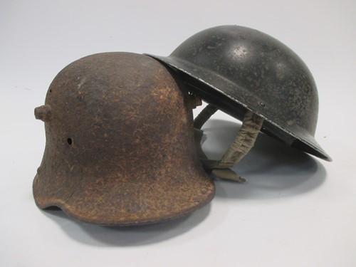 Lot 50 - Two First World War helmets - one English, one...