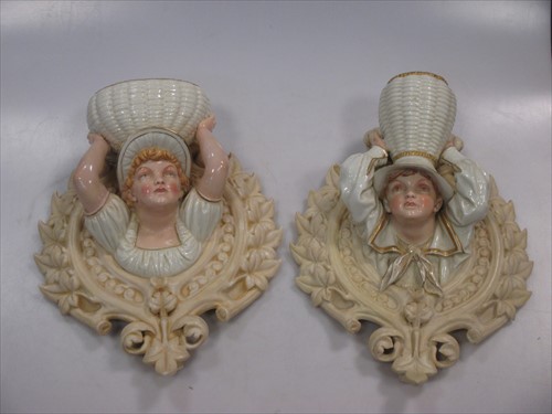 Lot 12 - Pair of Hadley Worcester porcelain wall pockets of a boy and girl with baskets.