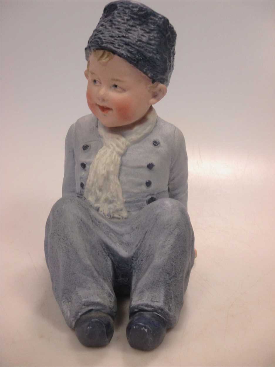 Lot 2 - A Heubach piano doll of a young boy.